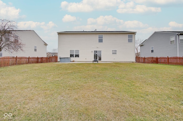 back of house with a yard and a patio area