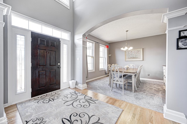 foyer featuring light hardwood / wood-style flooring and a chandelier