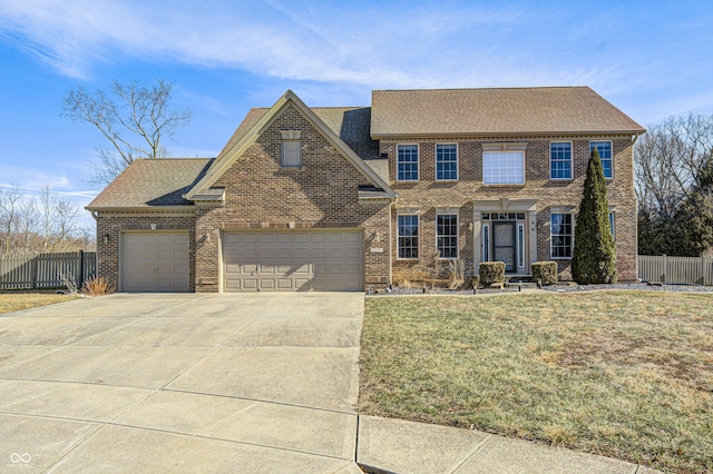 colonial-style house featuring a garage and a front lawn