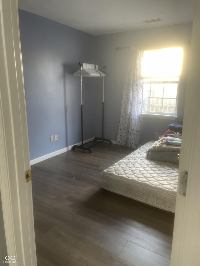 unfurnished bedroom featuring dark hardwood / wood-style flooring