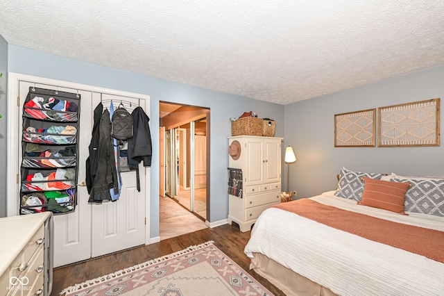 bedroom featuring dark hardwood / wood-style floors and a textured ceiling