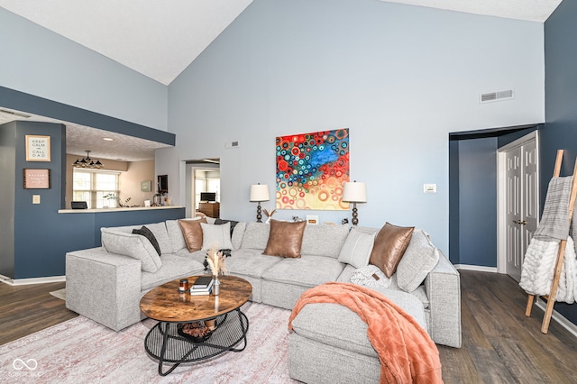 living room with wood-type flooring and high vaulted ceiling