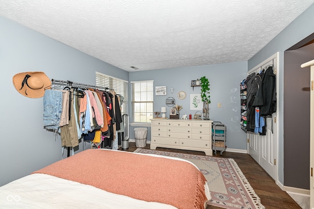 bedroom featuring wood-type flooring and a textured ceiling