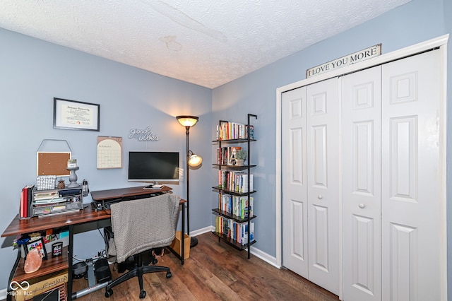 home office featuring dark hardwood / wood-style flooring and a textured ceiling