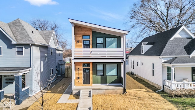 rear view of property with a balcony