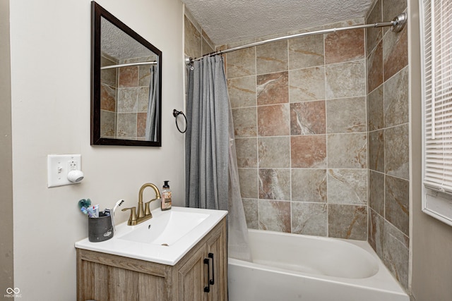 bathroom featuring vanity, shower / tub combo with curtain, and a textured ceiling