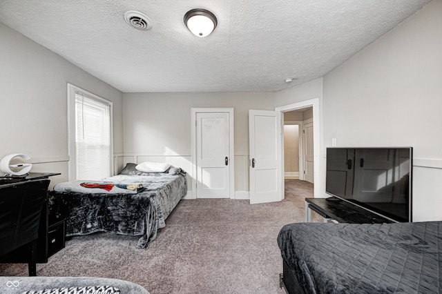 carpeted bedroom with a textured ceiling