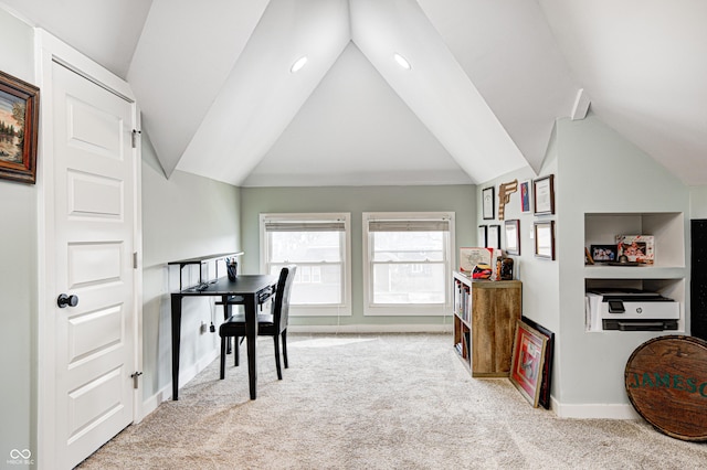 carpeted home office featuring lofted ceiling