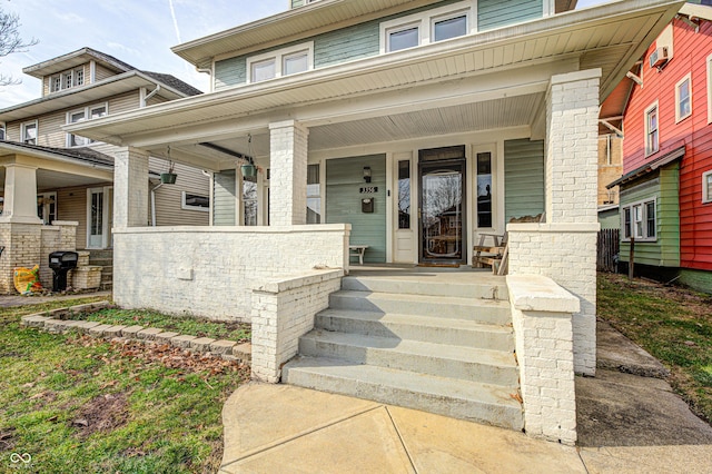 view of exterior entry with a porch