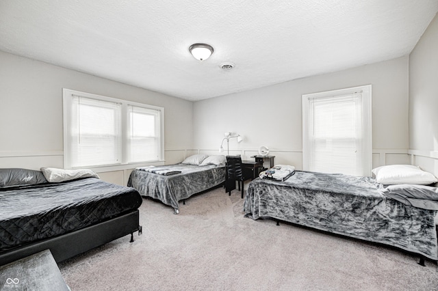 carpeted bedroom with a textured ceiling