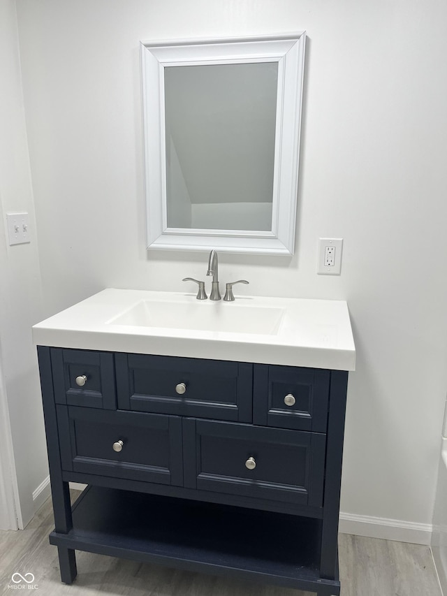 bathroom featuring vanity and hardwood / wood-style floors