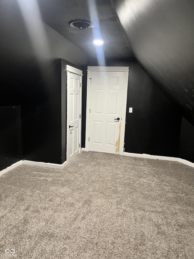 bonus room featuring vaulted ceiling and carpet floors