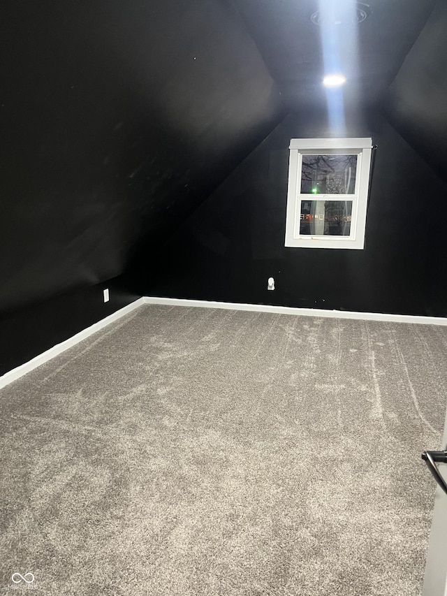 bonus room featuring lofted ceiling and carpet floors