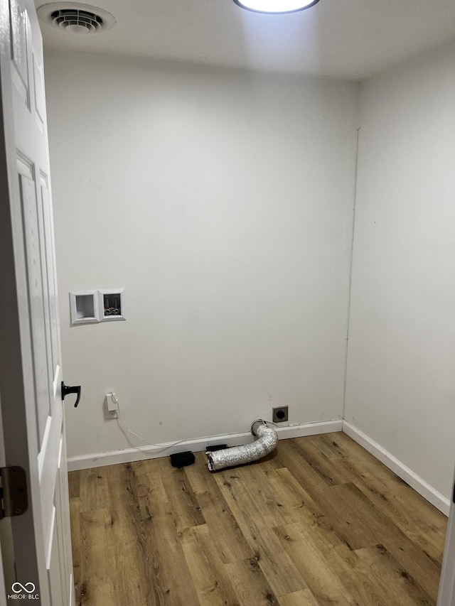 laundry room with wood-type flooring and electric dryer hookup