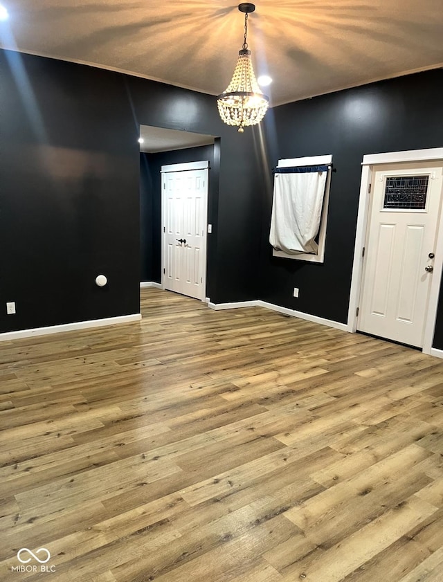 interior space with light hardwood / wood-style flooring and a chandelier