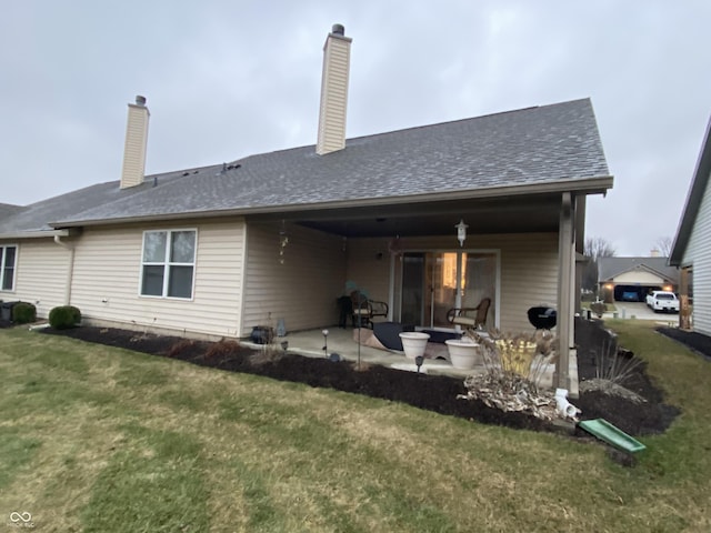 back of house with a lawn and a patio area