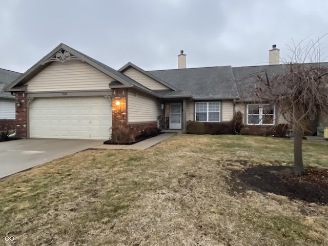 ranch-style home featuring a garage and a front lawn