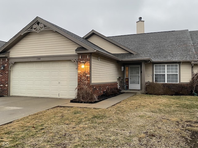 view of front of home with a garage and a front lawn