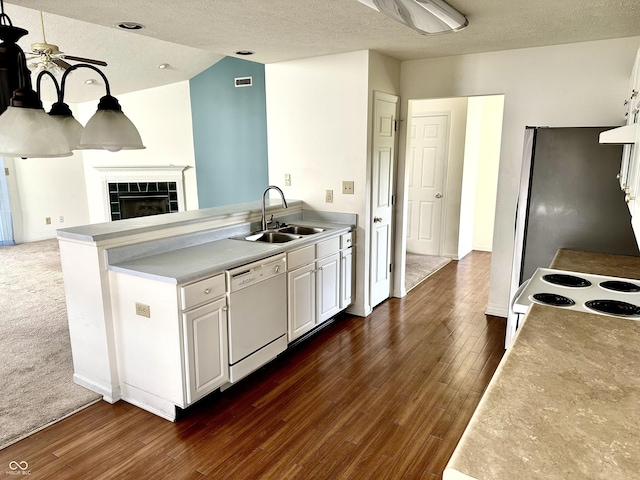 1348 Mccormicks Cir, Danville, IN 46122 - kitchen with white appliances, a sink, dark wood finished floors, a textured ceiling, and white cabinetry