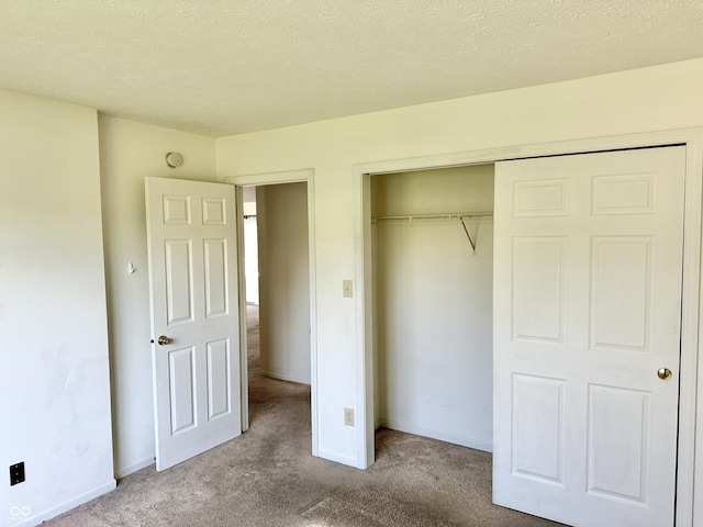 1348 Mccormicks Cir, Danville, IN 46122 - unfurnished bedroom with carpet, a closet, a textured ceiling, and baseboards