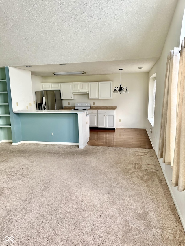1348 Mccormicks Cir, Danville, IN 46122 - kitchen featuring stainless steel fridge, electric stove, dark colored carpet, a chandelier, and white cabinets