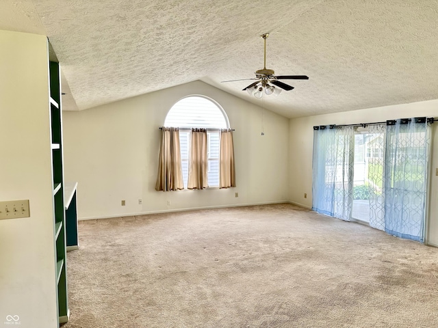 1348 Mccormicks Cir, Danville, IN 46122 - spare room with a ceiling fan, a textured ceiling, vaulted ceiling, carpet, and baseboards