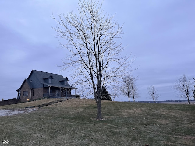 view of side of home with a lawn