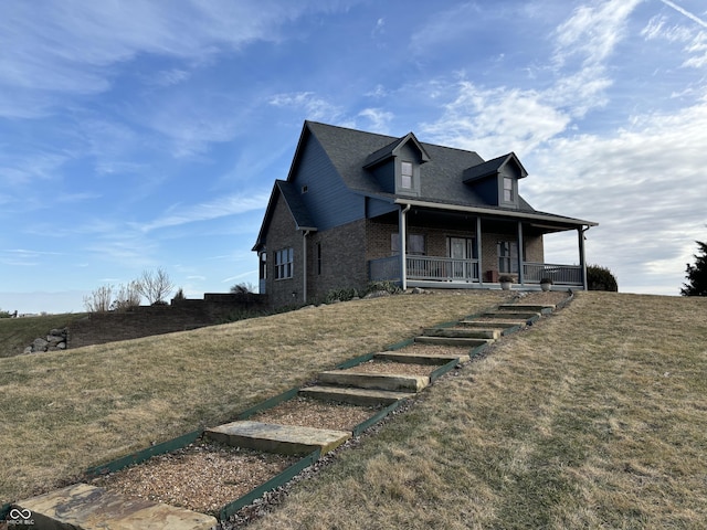 view of front of property with a porch and a front yard