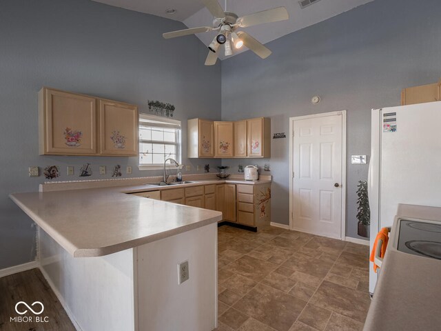 6264 Whitaker Farms Dr, Indianapolis, IN 46237 - kitchen with a breakfast bar, light brown cabinetry, sink, white fridge, and kitchen peninsula