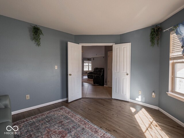 6264 Whitaker Farms Dr, Indianapolis, IN 46237 - unfurnished bedroom with multiple windows and hardwood / wood-style floors