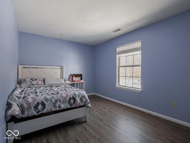 6264 Whitaker Farms Dr, Indianapolis, IN 46237 - bedroom featuring dark hardwood / wood-style floors and a textured ceiling
