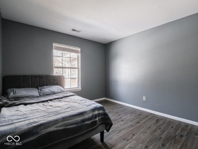 6264 Whitaker Farms Dr, Indianapolis, IN 46237 - bedroom featuring dark hardwood / wood-style floors and a textured ceiling