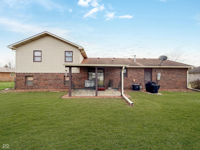 back of property featuring central AC, a lawn, and a patio area