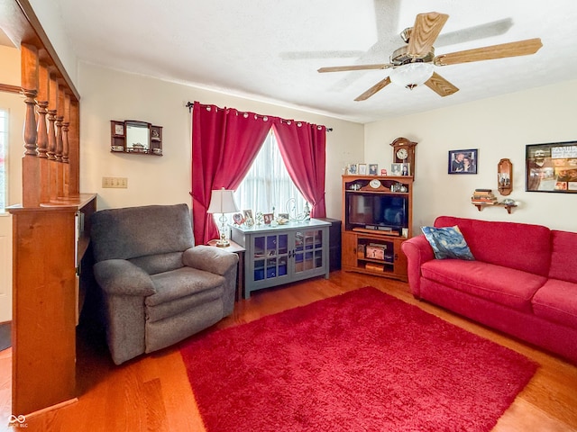 living room featuring hardwood / wood-style flooring and ceiling fan