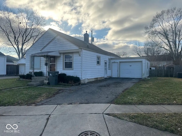 view of front of property featuring a garage and a front lawn