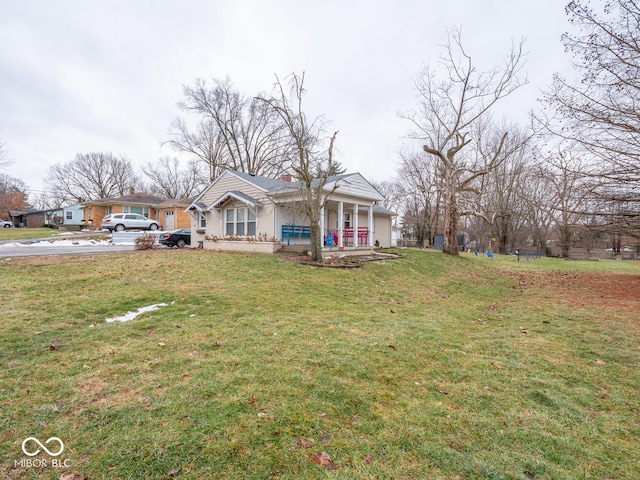 view of front of home featuring a front yard and covered porch