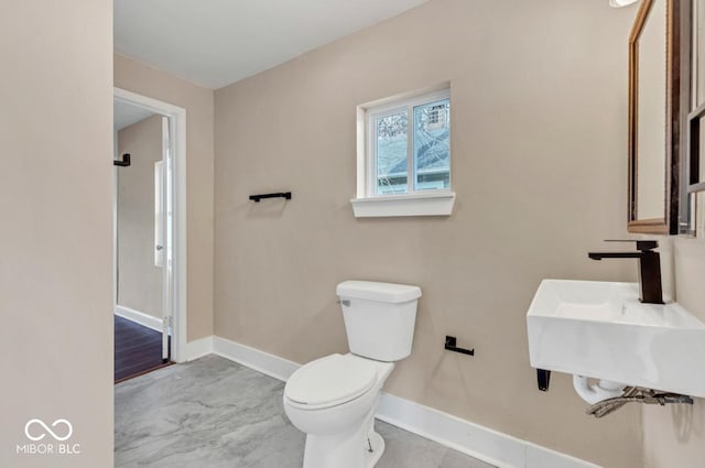 bathroom featuring sink and toilet