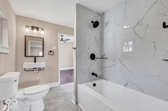 full bathroom with ceiling fan, tiled shower / bath, toilet, and sink