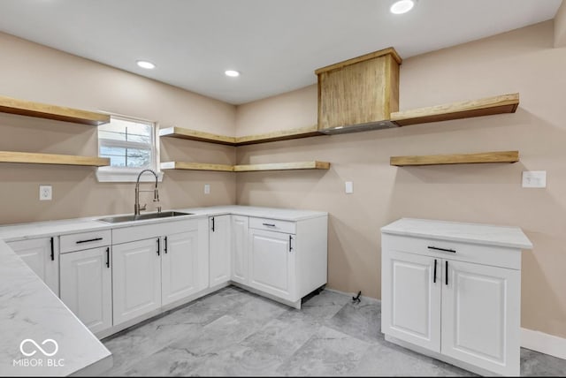 kitchen with white cabinetry and sink