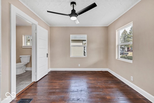 spare room with ornamental molding, dark wood-type flooring, and ceiling fan