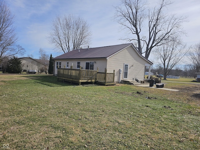 back of house with a yard and a deck