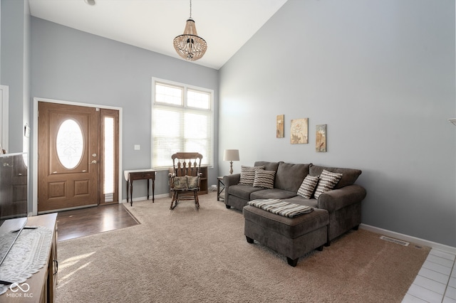 living room with an inviting chandelier and high vaulted ceiling