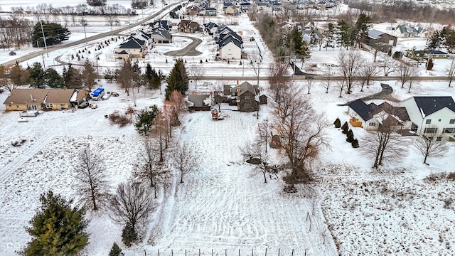 snowy aerial view featuring a residential view