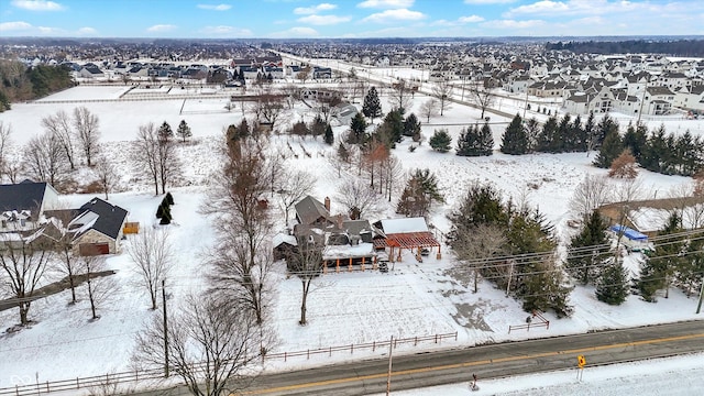 snowy aerial view featuring a residential view