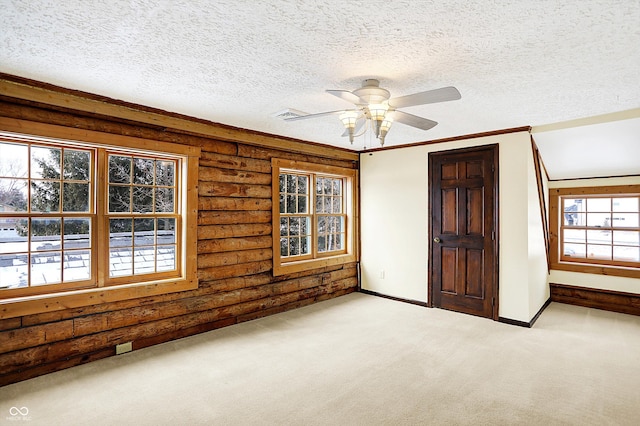 unfurnished bedroom featuring a ceiling fan, baseboards, visible vents, light colored carpet, and a textured ceiling