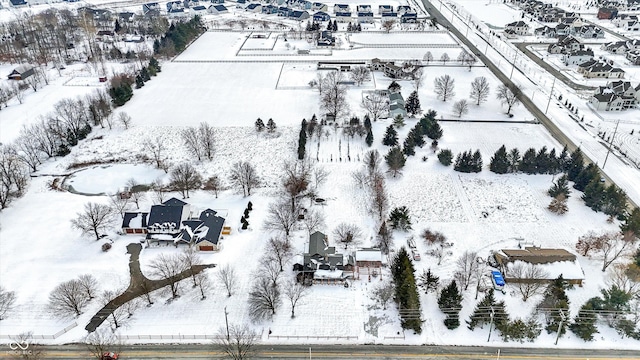 snowy aerial view with a residential view