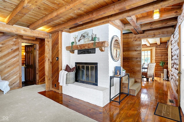 living room featuring wood ceiling, beamed ceiling, and log walls