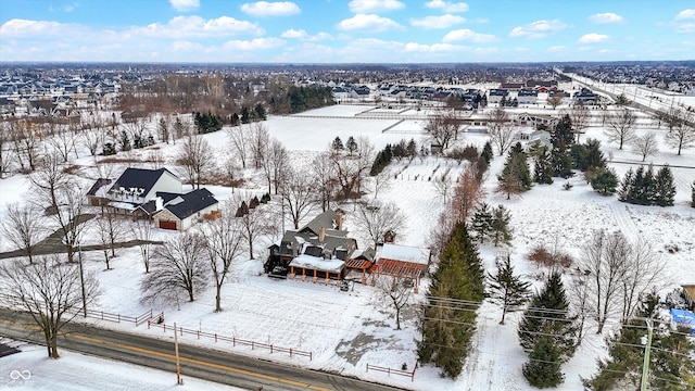 snowy aerial view featuring a residential view