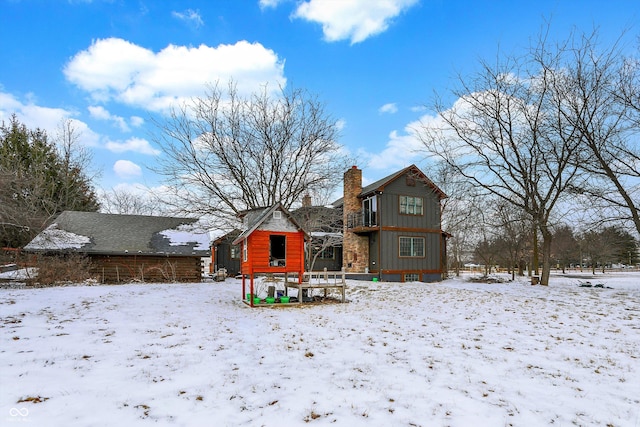 snow covered house with a chimney