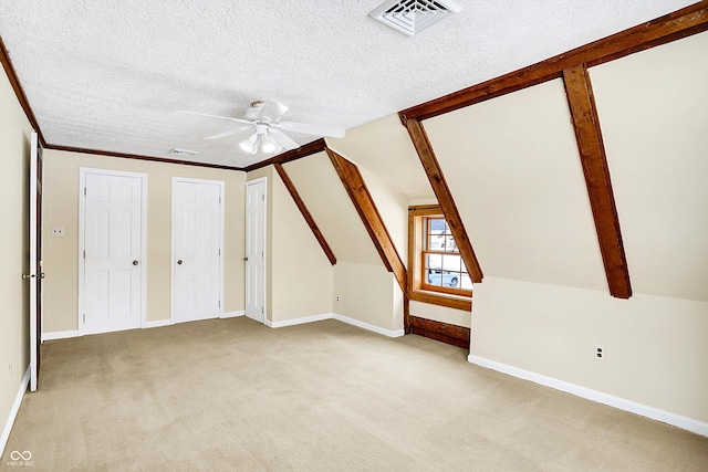 bonus room with visible vents, light colored carpet, lofted ceiling with beams, and a textured ceiling